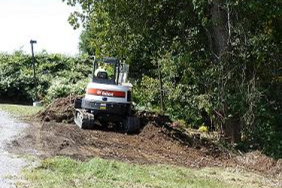 A Bobcat Moving Dirt
